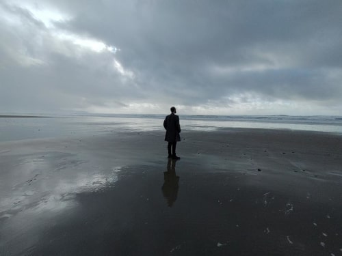 Joe Goose standing on the beach